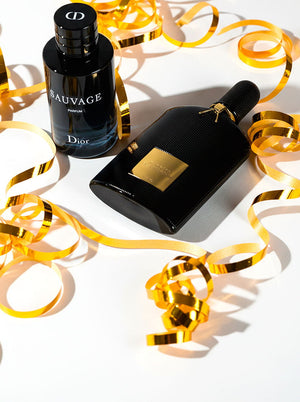 Dior Sauvage and Tom Ford Black Orchid perfumes showcased with golden ribbon, highlighting luxury fragrance picks.