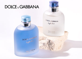 Dolce & Gabbana Light Blue fragrances for men displayed on a white surface with a stone prop and brand logo. 6