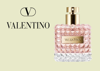 Valentino perfume in a blush pink and crystal-clear studded bottle with gold accents, placed on a soft neutral green background with elegant logo text. 4